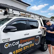 Plumber beside a fully equipped service van, Parkdale